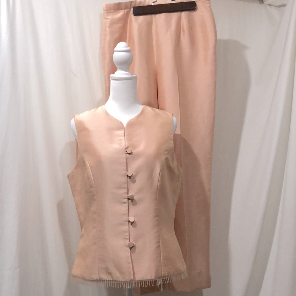 A sleeveless tuxedo style pants suit